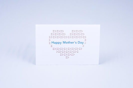 A big heart made of tactile braille with greeting in the middle